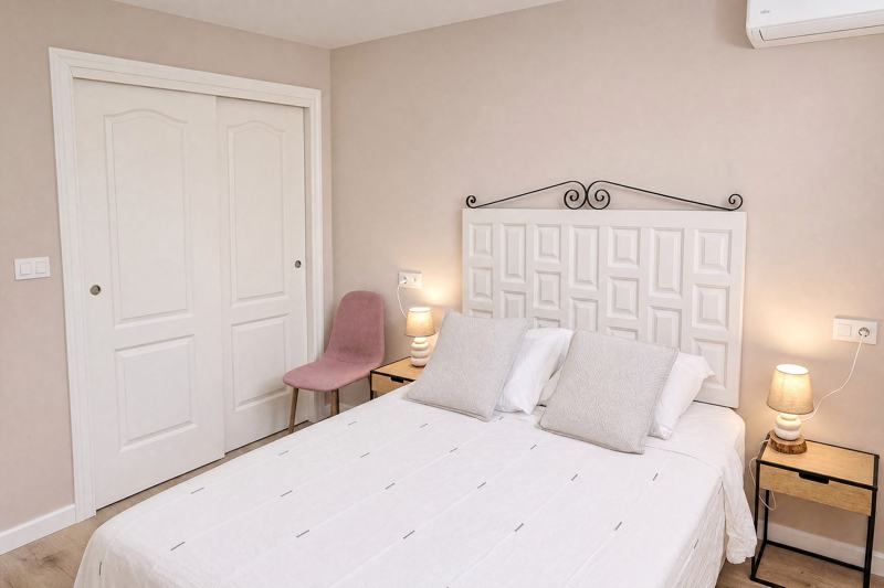 Bedroom with a built-in wardrobe and two bedside lamps